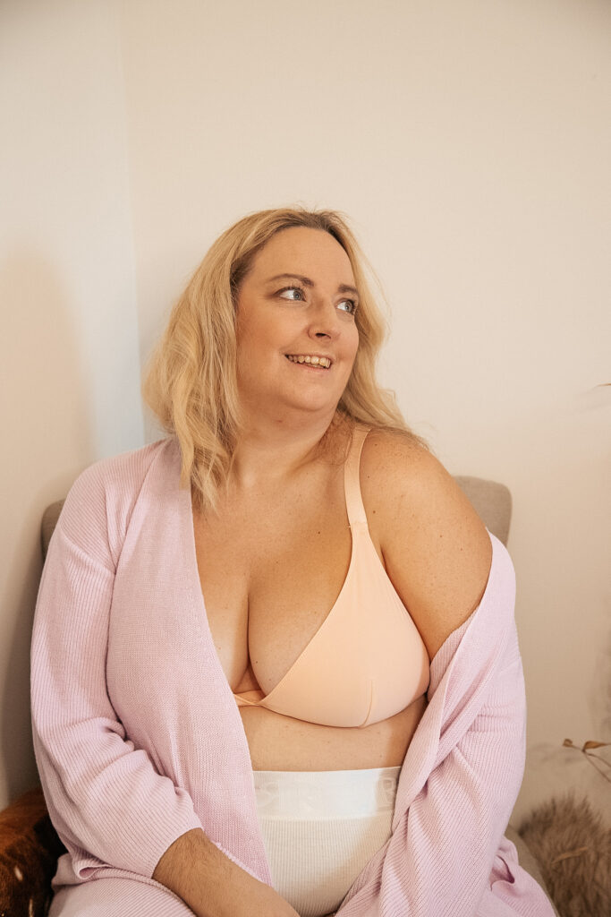 lucy in a peach bra with lilac cardigan