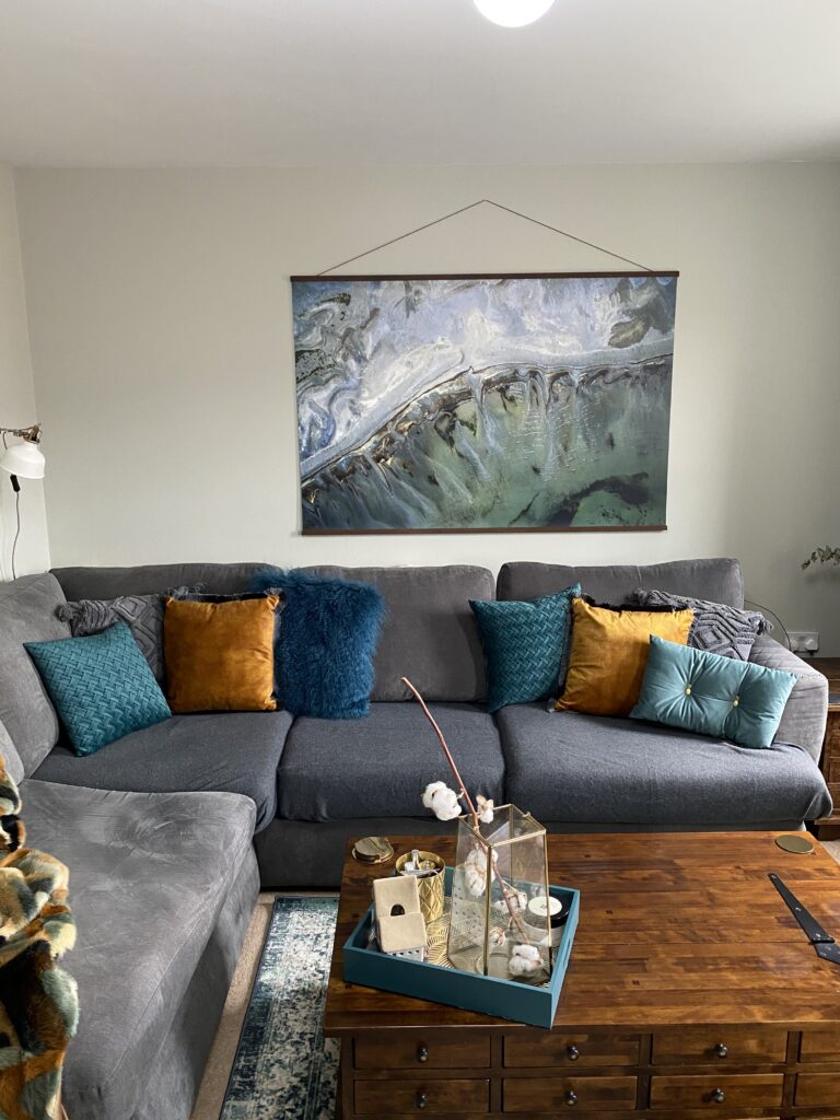styled sofa with cushions and the wall art 