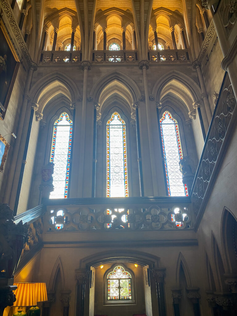 inside the castle with tall stained glass windows