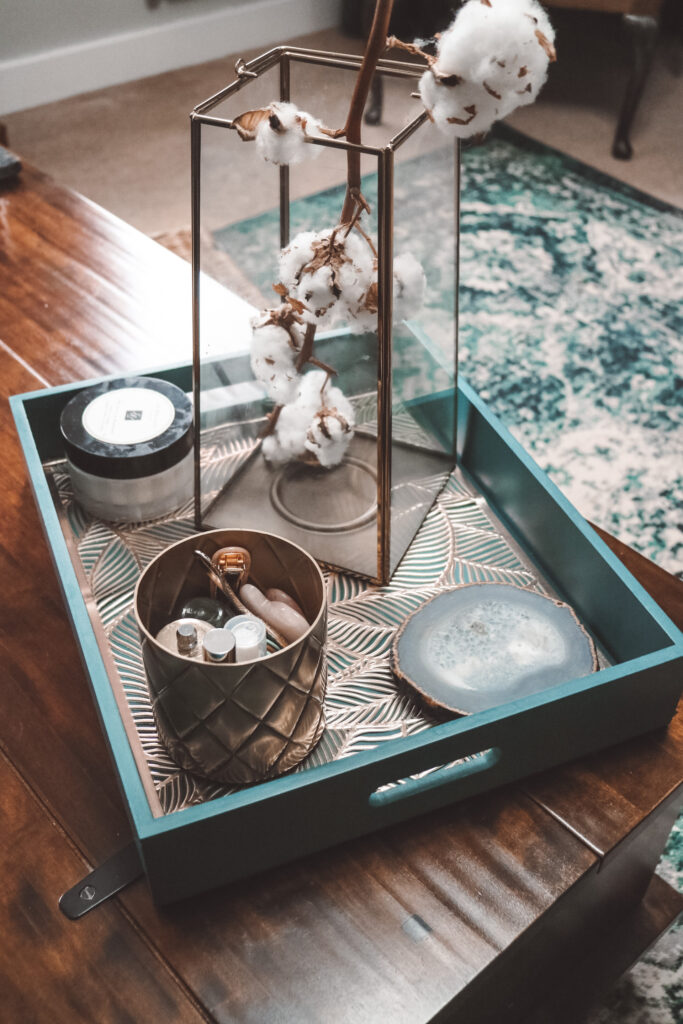 tray with decor on the coffee table with the rug in the background
