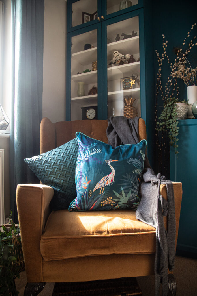 Heron design cushion with a teal cushion