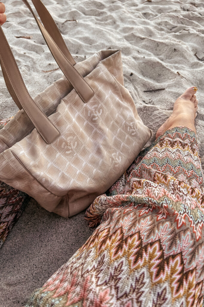 vintage chanel travel line tote on the beach as sun sets 