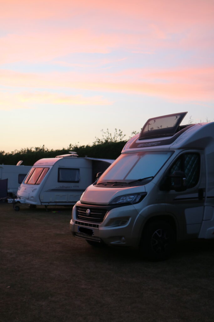 Motorhome and caravan at sunset