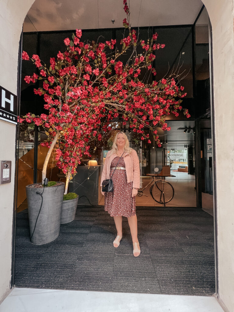 lucy stood in front of a faux blossom tree in the hotels entrance