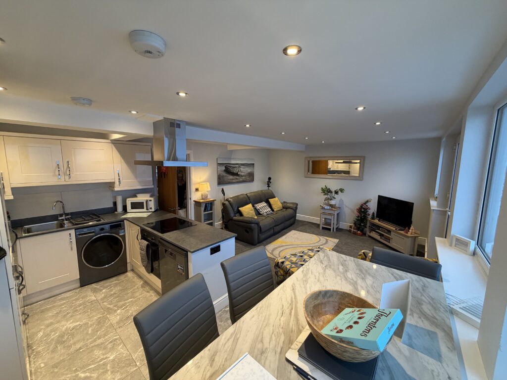 the open living area, kitchen and high dining table