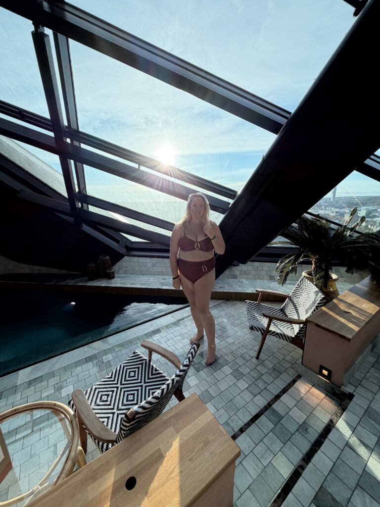 lucy stood poolside in a rust bikini